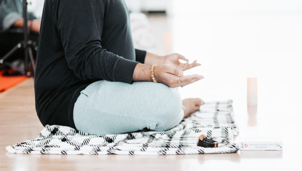 Meditation space set with mats, blankets, and flickering candles at a Stillness wellness retreat